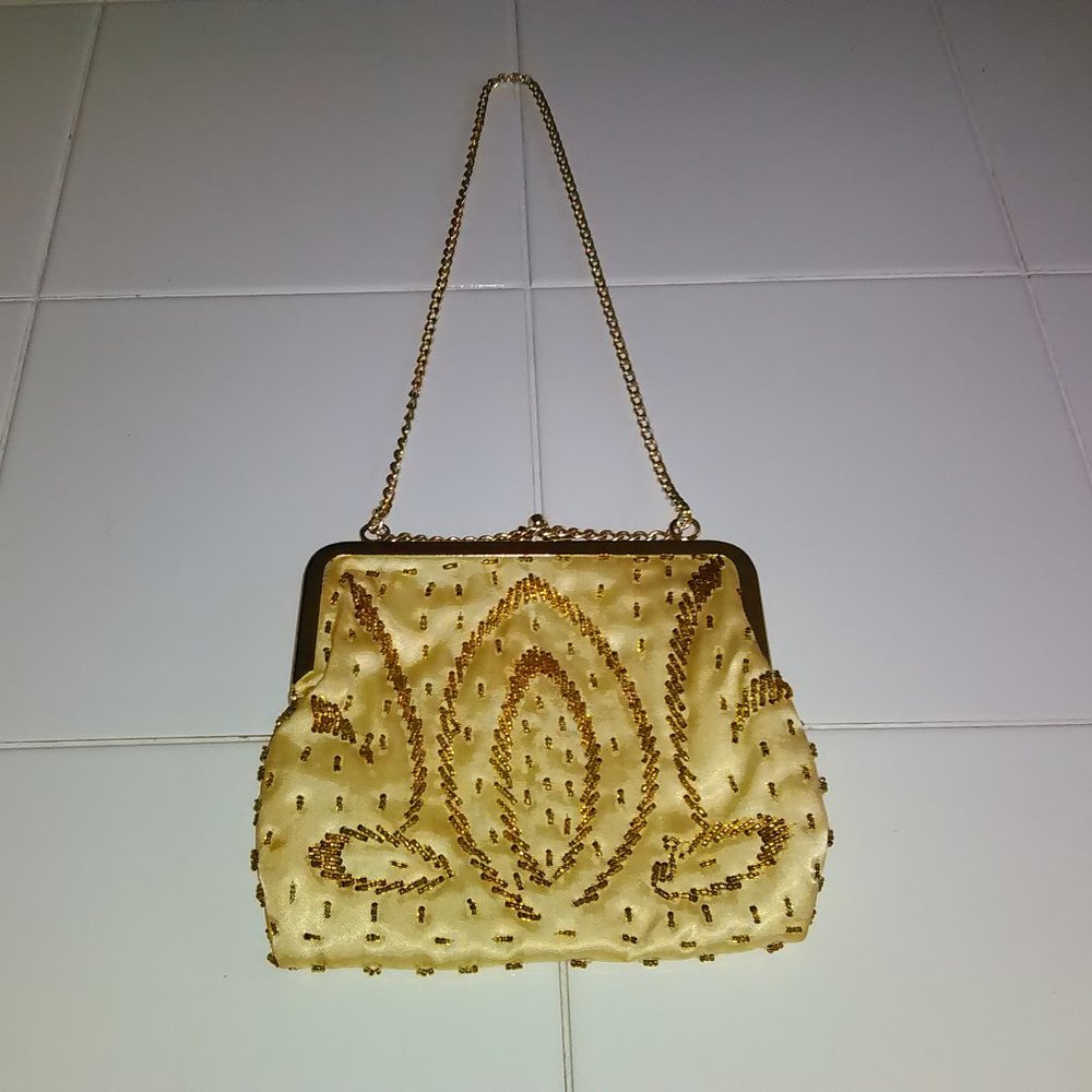 Small vintage cream/gold handbag.